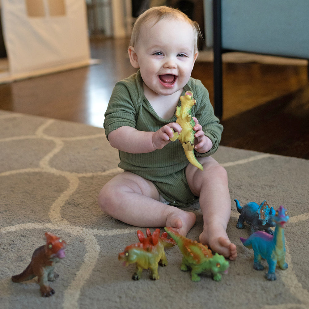 Toddler playing with Soft Squeezable Dinosaur Toys