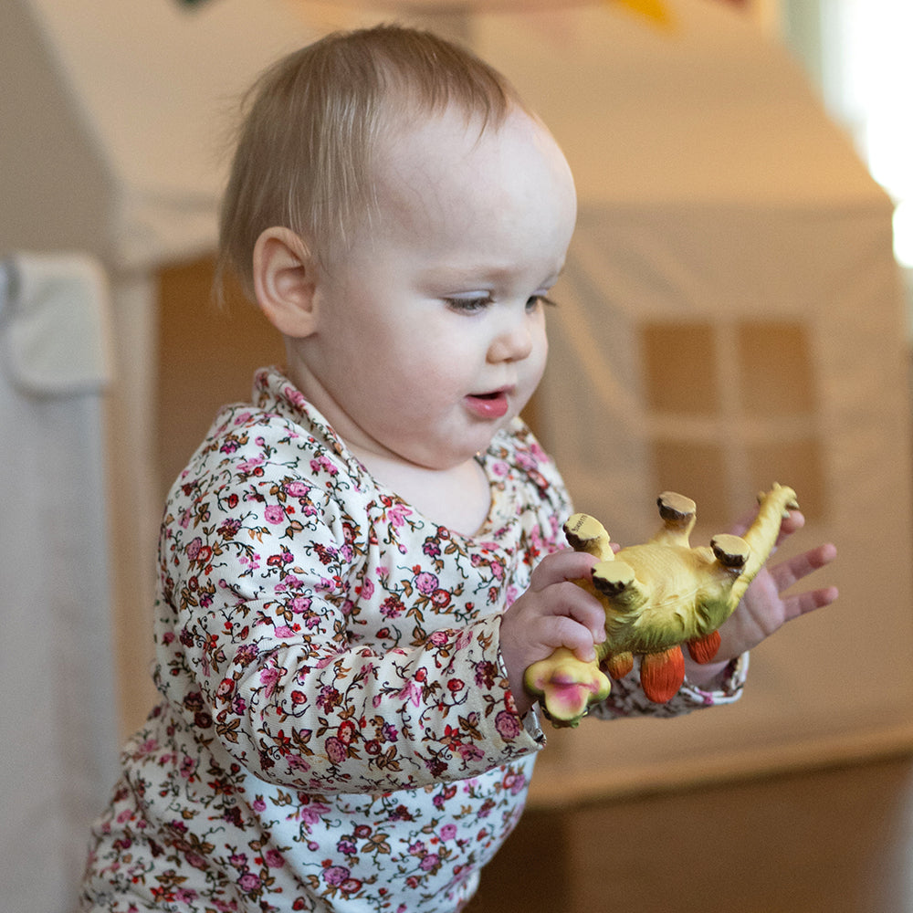 Toddler Holding Soft Squeezable Dinosaur Toy