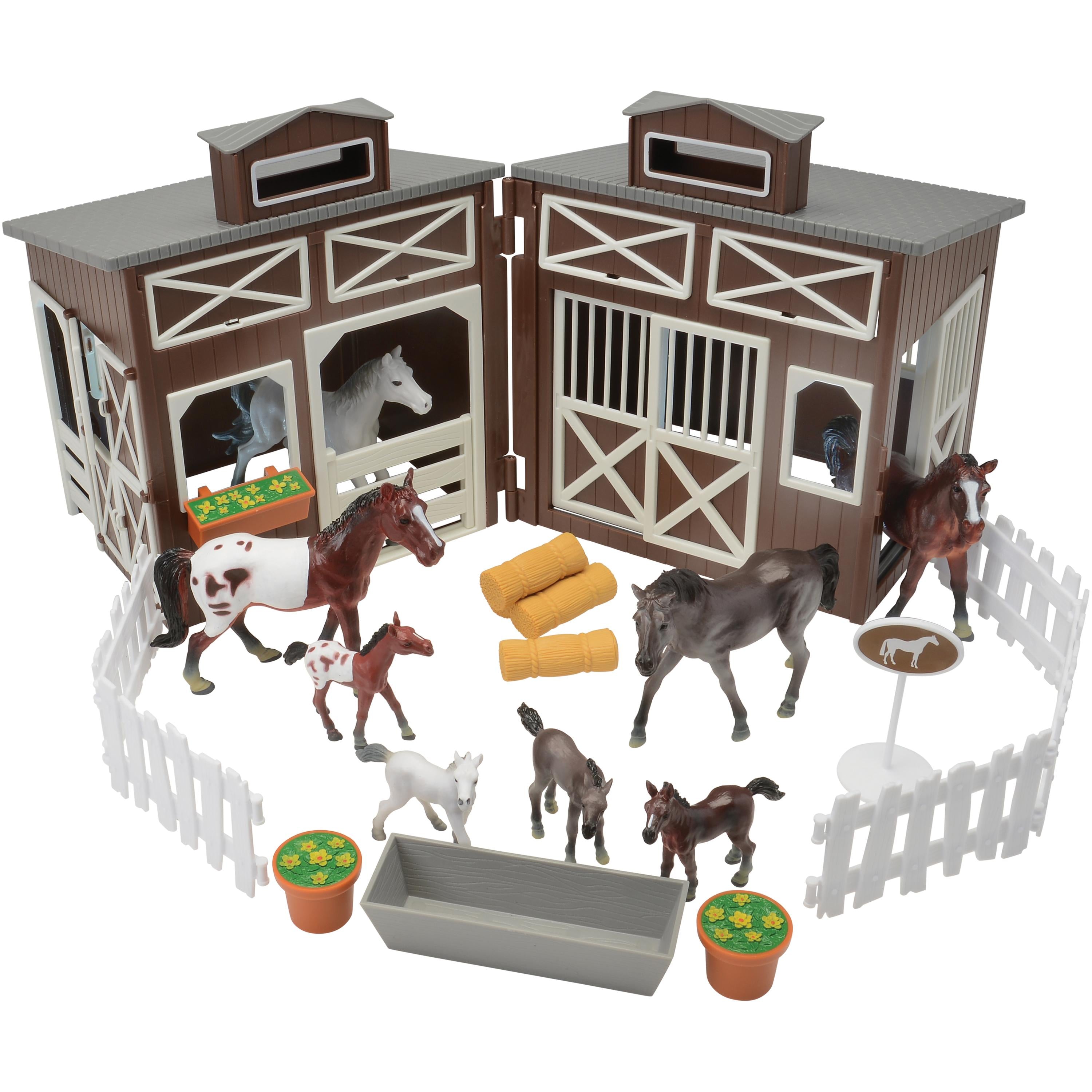 Toy stable set with horses and accessories on a white background