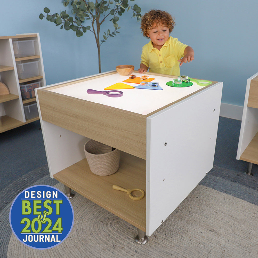 Child playing at a wooden activity table with toys in a room setting, featuring the 'Best 2024' design award badge.