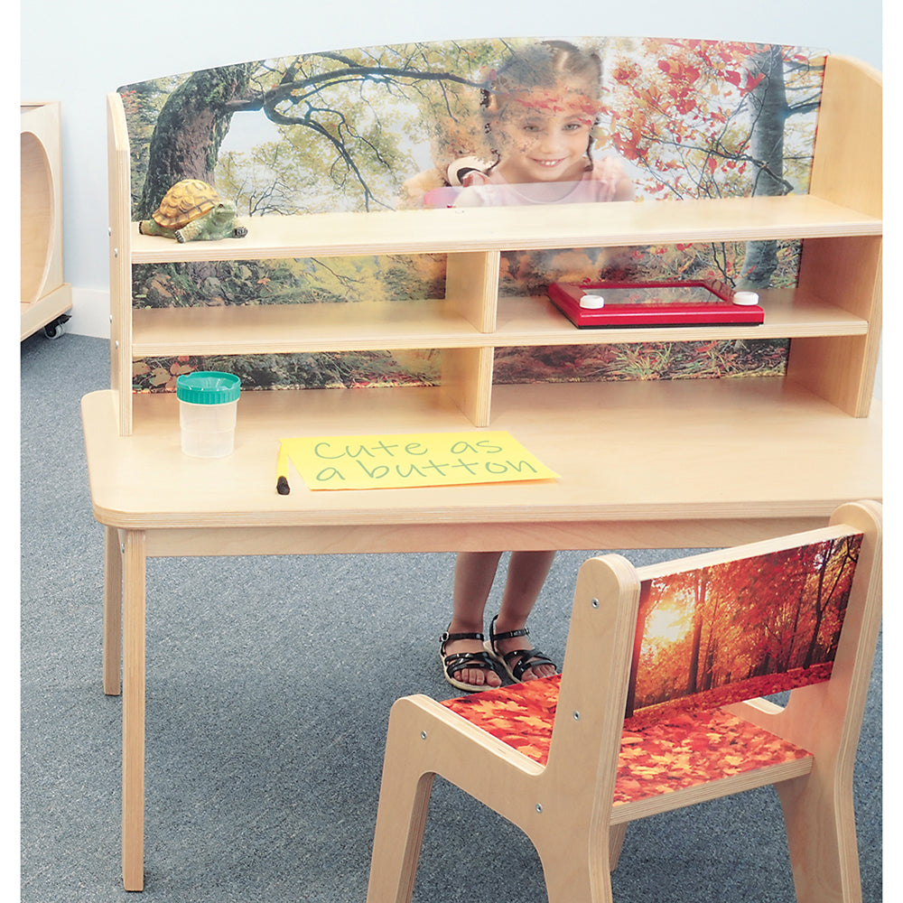 Children's desk and chair set with nature-themed backrests and a child standing behind.