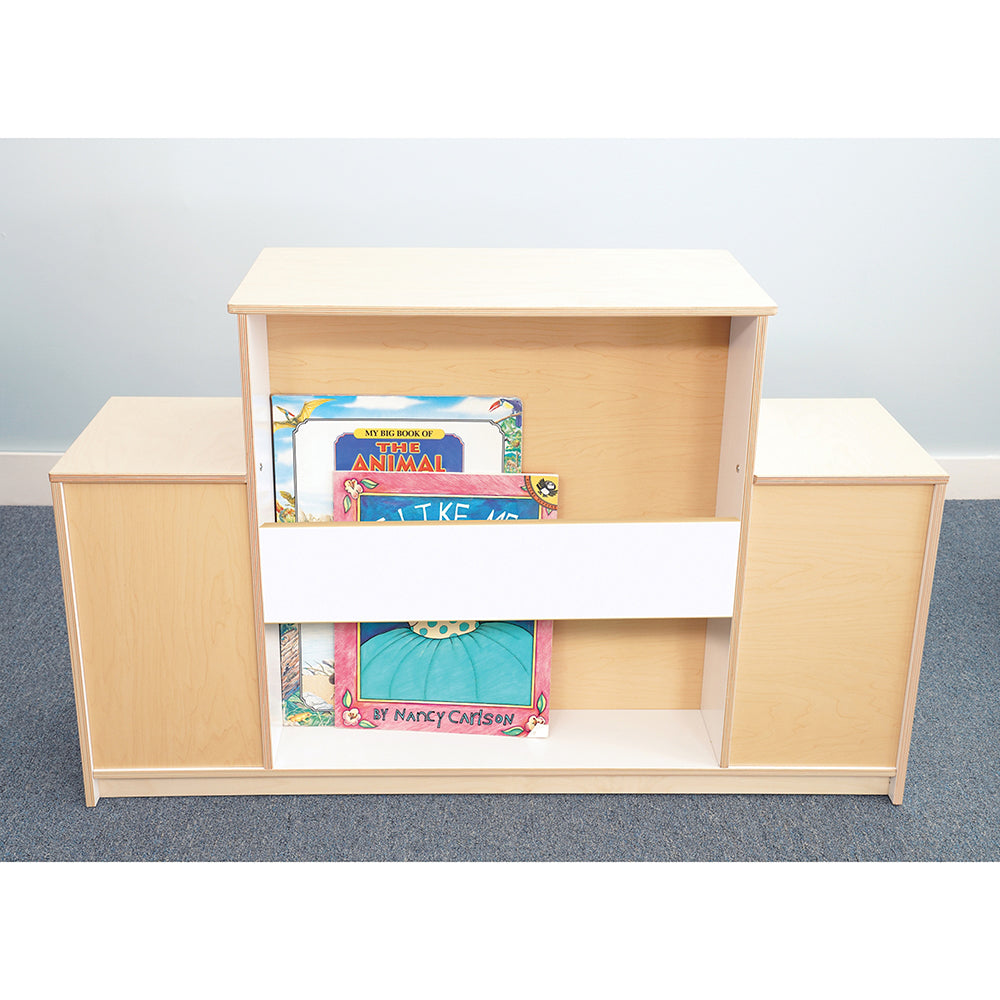 Wooden bookshelf with books on a gray floor and light blue wall