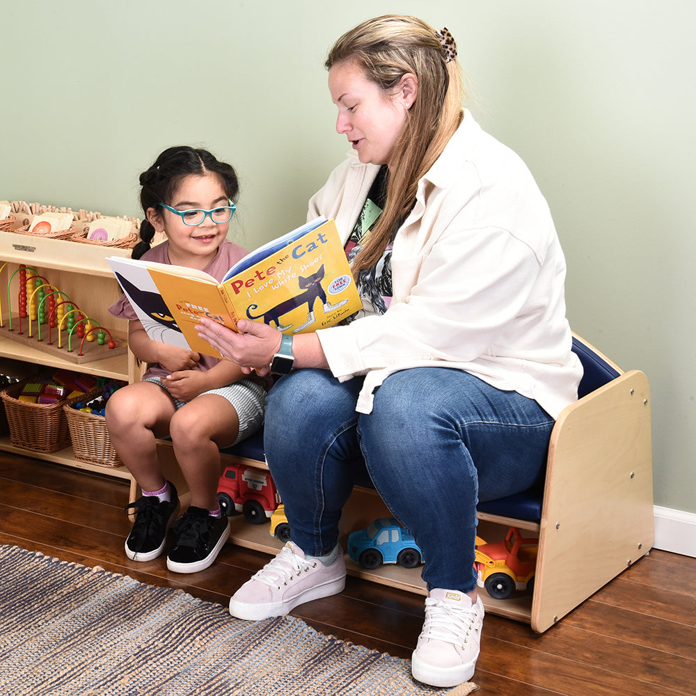 Teacher and Kid Using the Classic Classroom Couch in the Literacy Corner