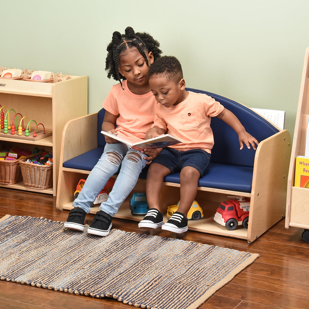 Two Kids Reading a Book while Seated on Classic Classroom Couch