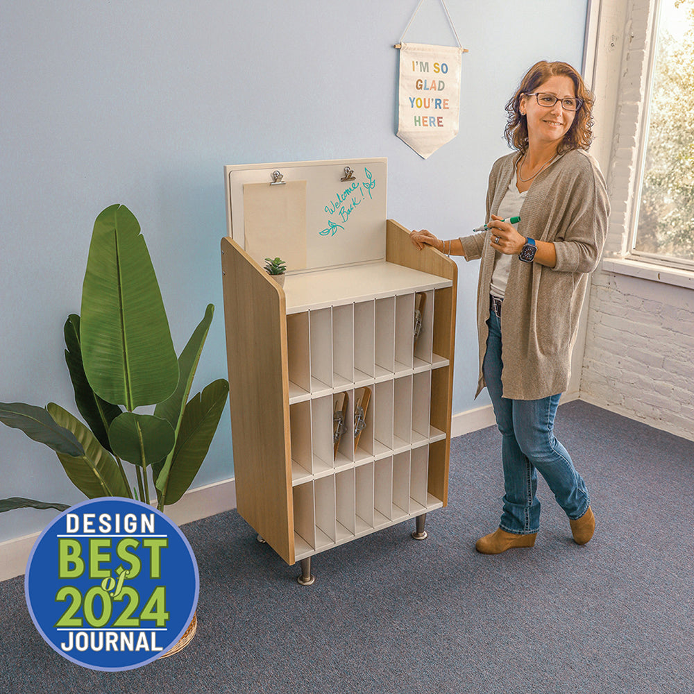 Woman standing next to a wooden bookshelf with a 'Design Best 2024 Journal' badge in the corner.