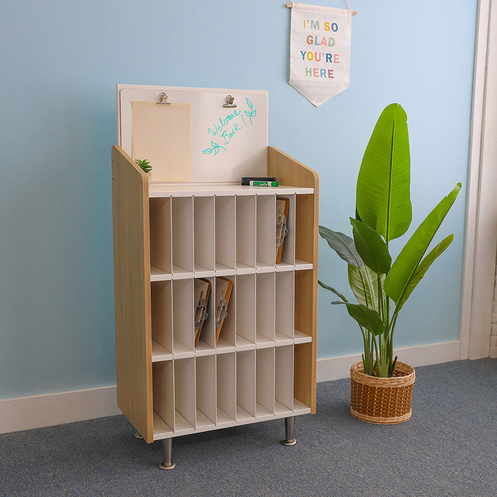 Wooden storage unit with shelves against a light blue wall, next to a potted plant.