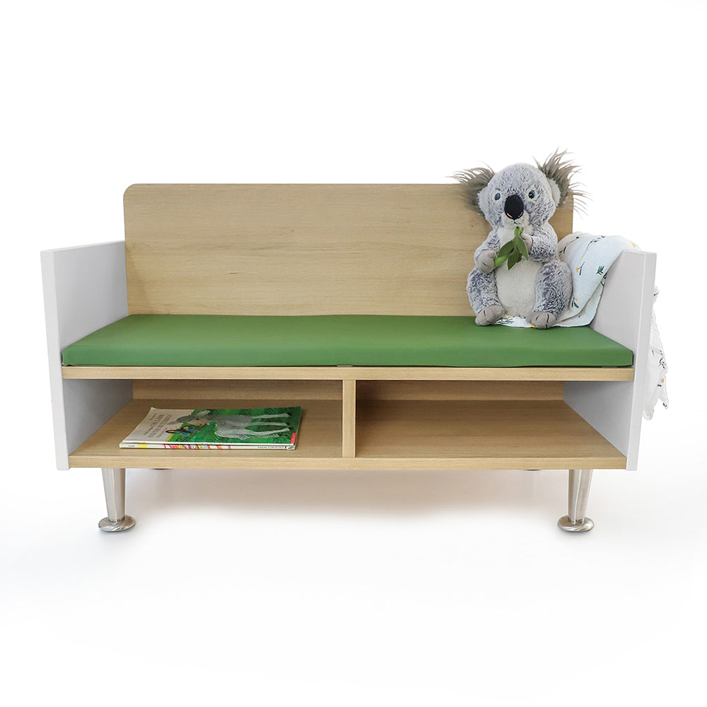 Children's bench with green cushion and toy on a white background