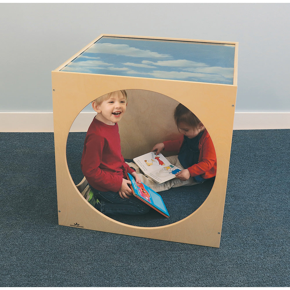 Children's playhouse with a round window showing two children playing.