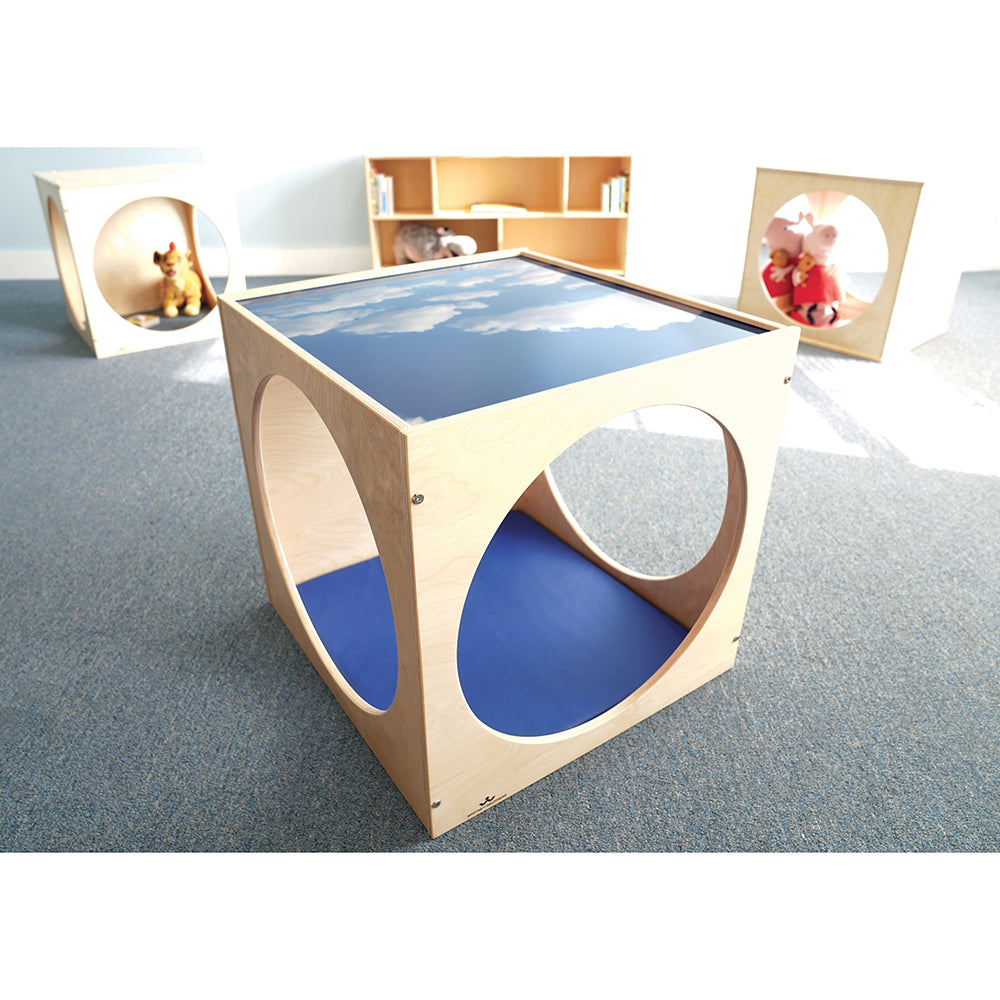 Children's play table with cloud design on a gray floor