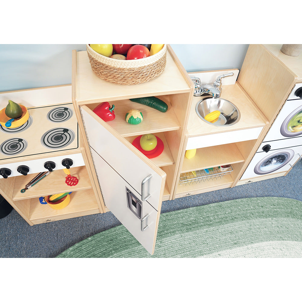 Wooden play kitchen set with toy stove, sink, and shelves on a carpeted floor.