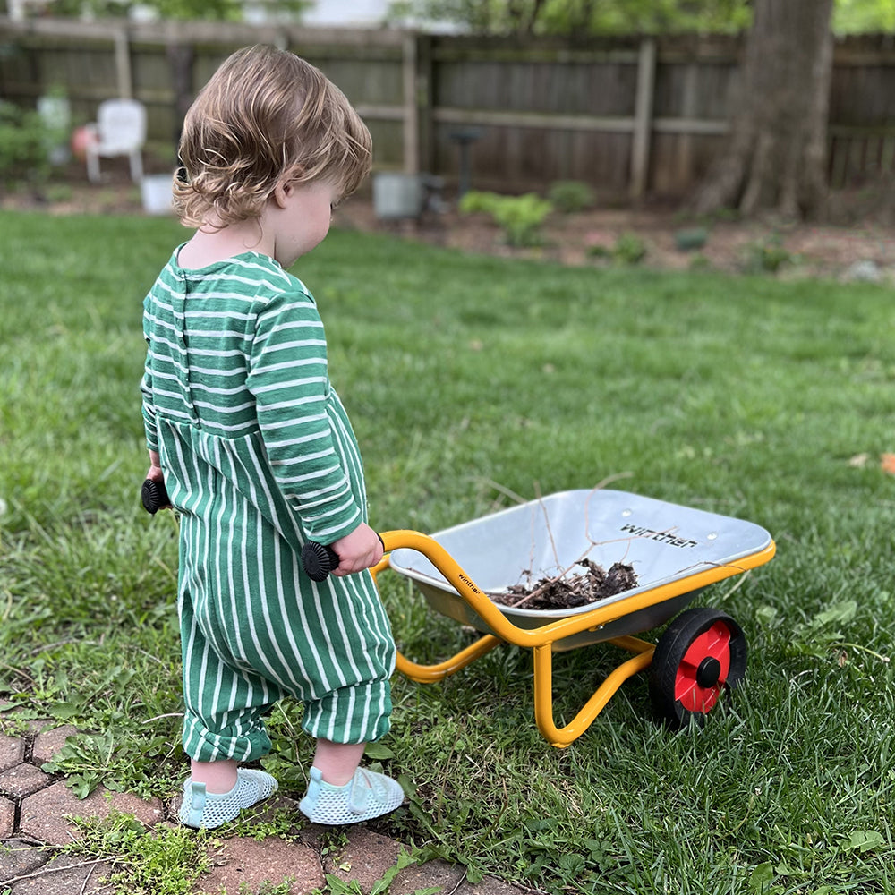 Toddler Pushing Wheelbarrow