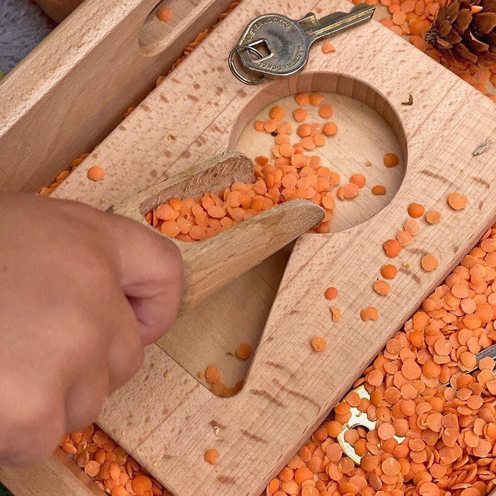 Toddler Using Little Looking Discovery Home-Themed Shapes with other sensory materials