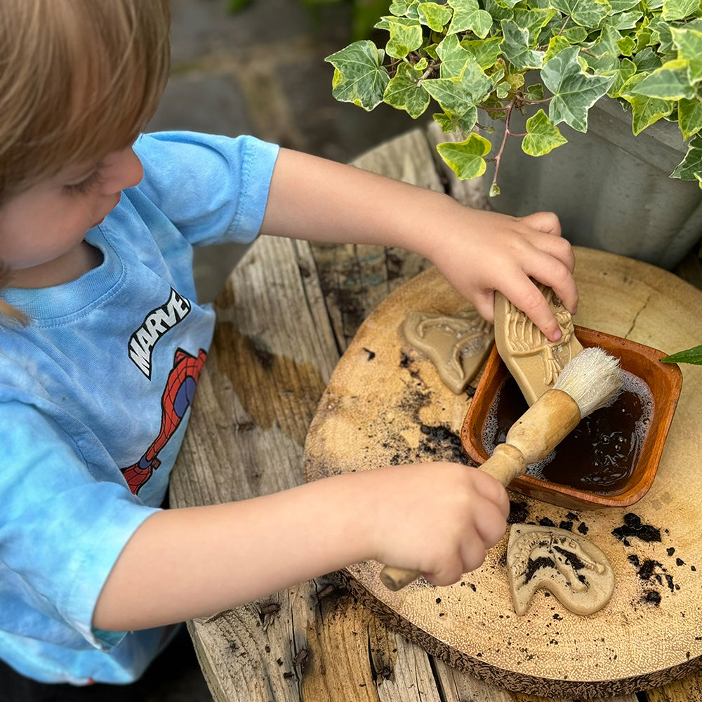 Brushing Dirt off Dinosaur Fossil Pieces