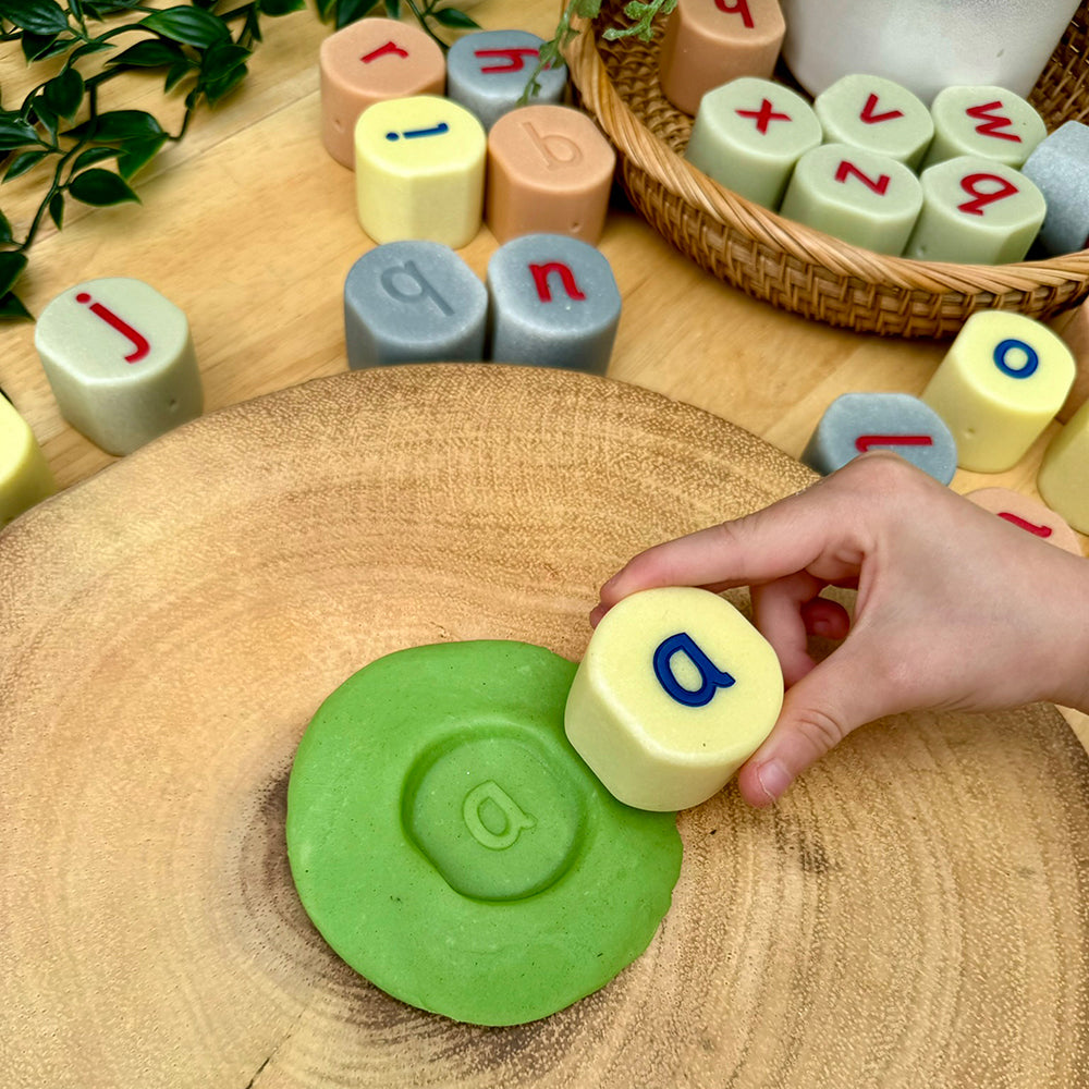 Kid Pressing Letter A Alphabet Stone into Modeling Dough
