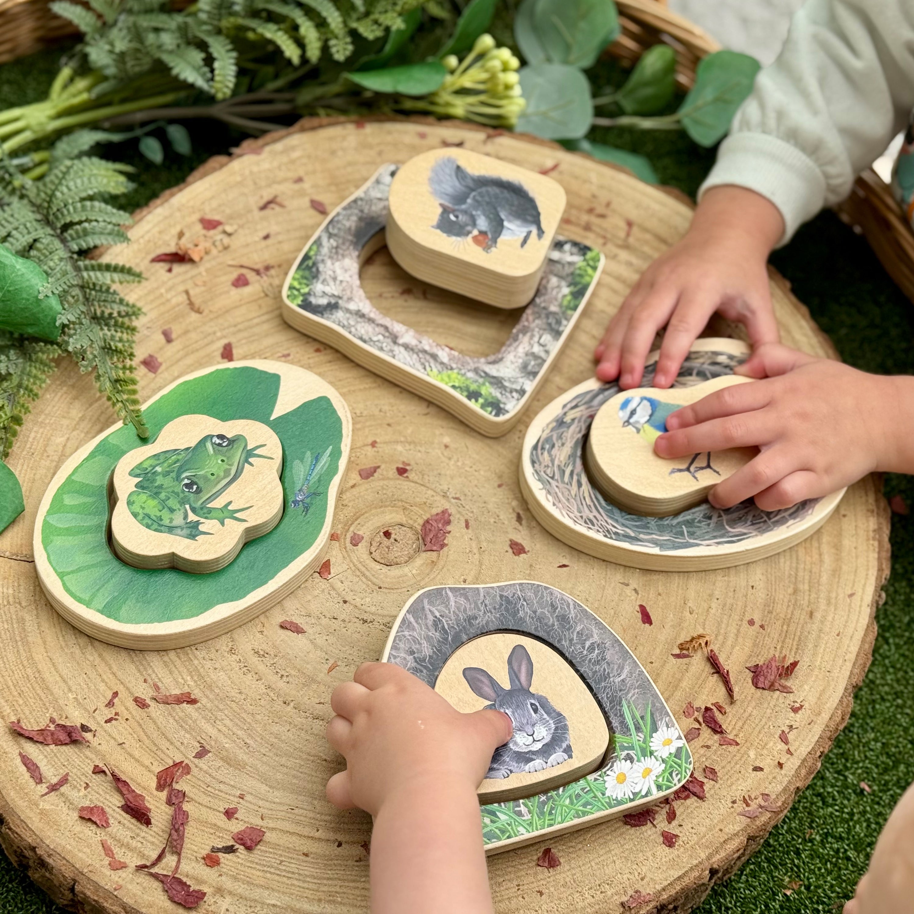 Children playing with animal-themed wooden toys on a natural wooden surface.