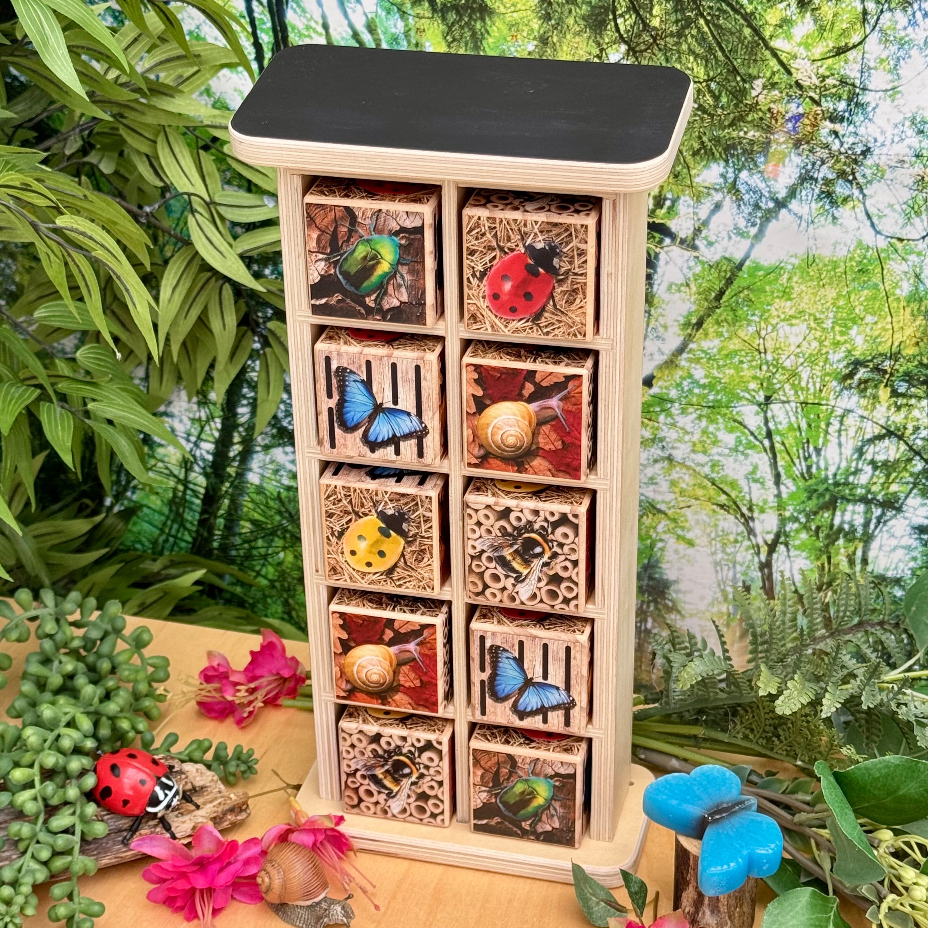 Wooden insect house with various compartments against a natural background