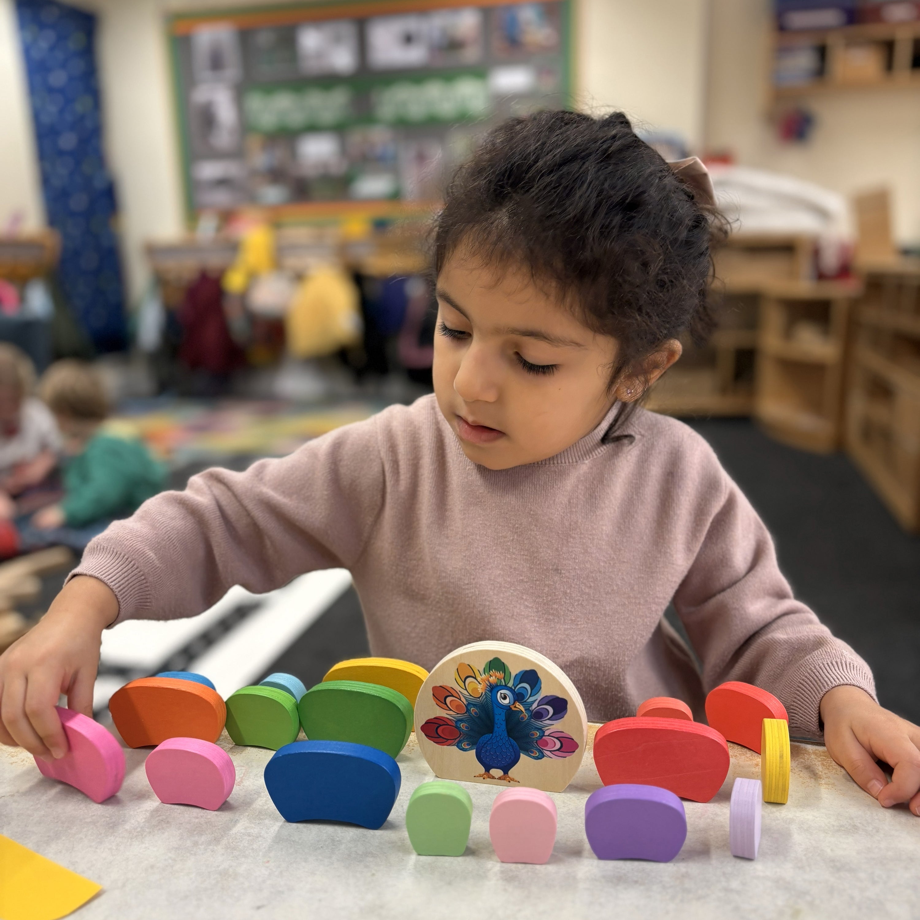 Child playing with colorful educational toys in a classroom setting