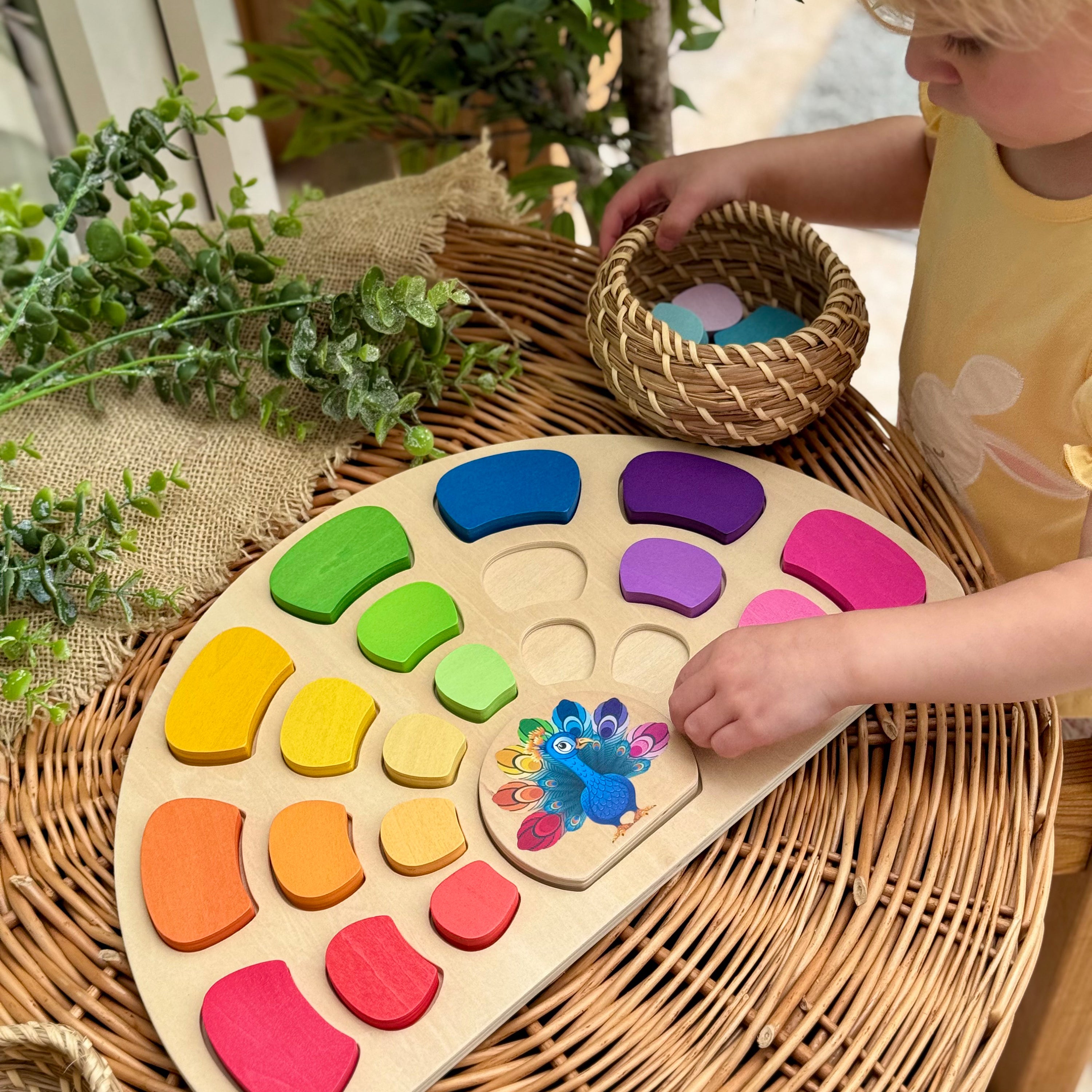 Child playing with a wooden color sorting toy on a woven surface.