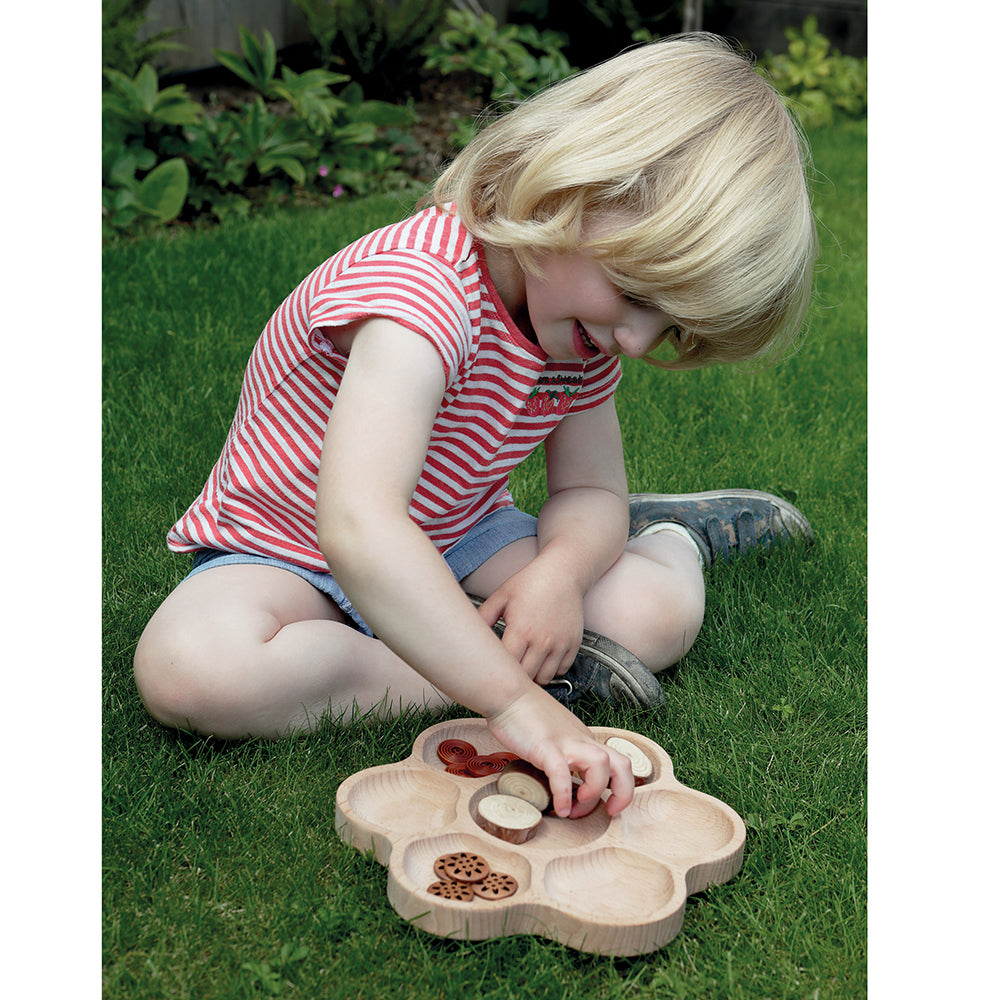 Kid Outdoors Using Wooden Flower Tray for Nature Sorting