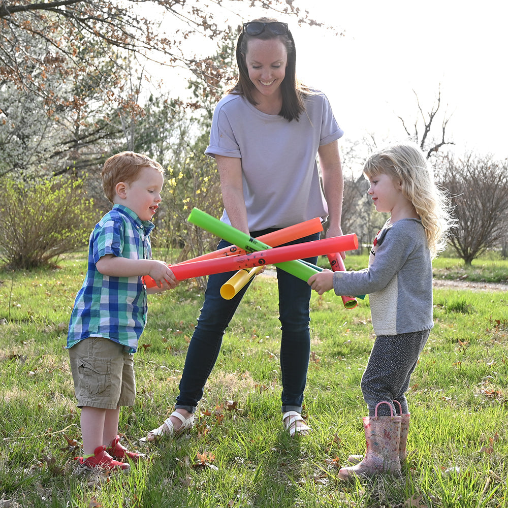 Adult & Two Children Outdoors Engaging with Boomwhackers® Musical Tubes