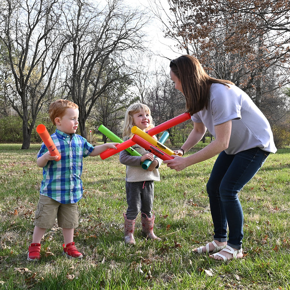Teacher Showing Two Children How to Use Boomwhackers® Musical Tubes
