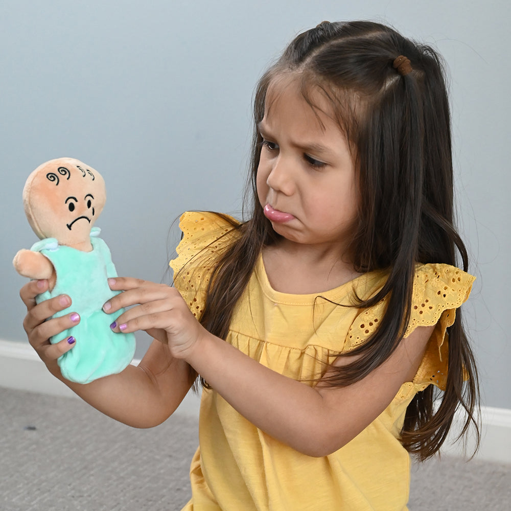 Kid Mimicking Sadness with Expression Baby Dolls