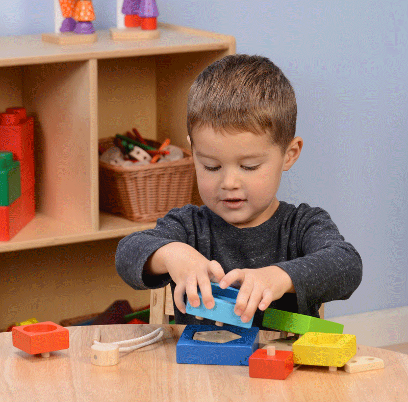 Motion Image of Kid Stacking Shapes