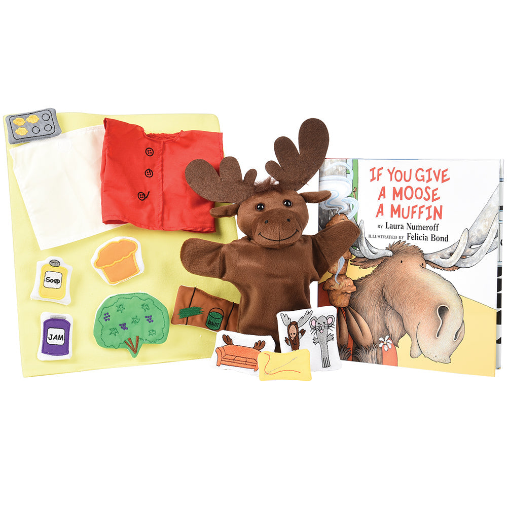 A set including a moose puppet, various prop pieces, and a hardcover book titled 'If You Give A Moose A Muffin'.