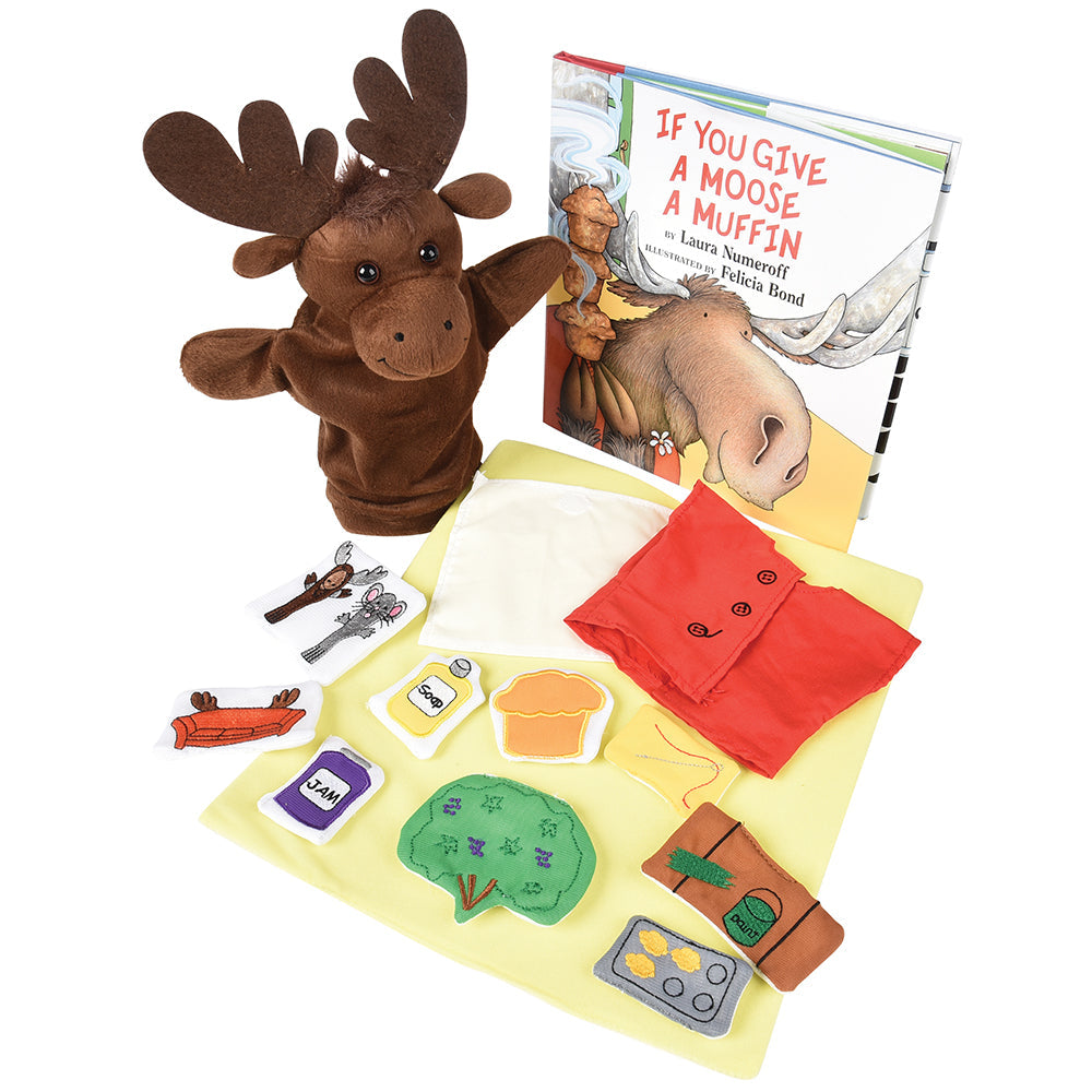 A set including a moose puppet, various prop pieces, and a hardcover book titled 'If You Give A Moose A Muffin'.