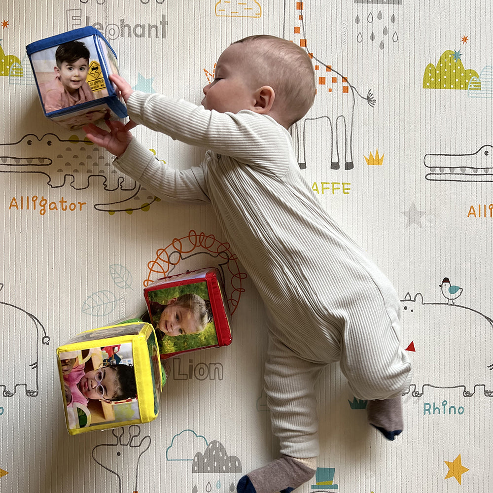 Baby Reaching For Stacking Blocks with Photo Pockets