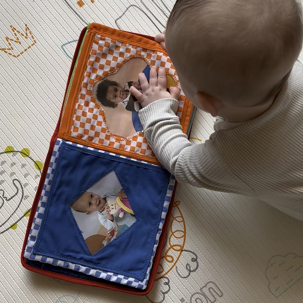Baby Grasping Soft Pages of Baby's First Photo Album