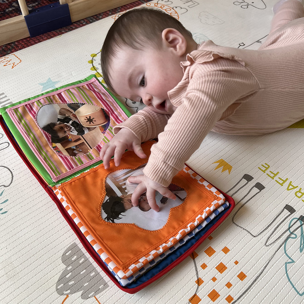 Baby Reaching for Baby's First Photo Album