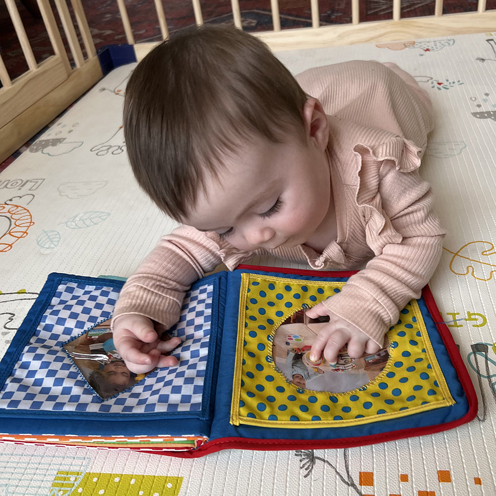 Baby Touching Pages of Baby's First Photo Album