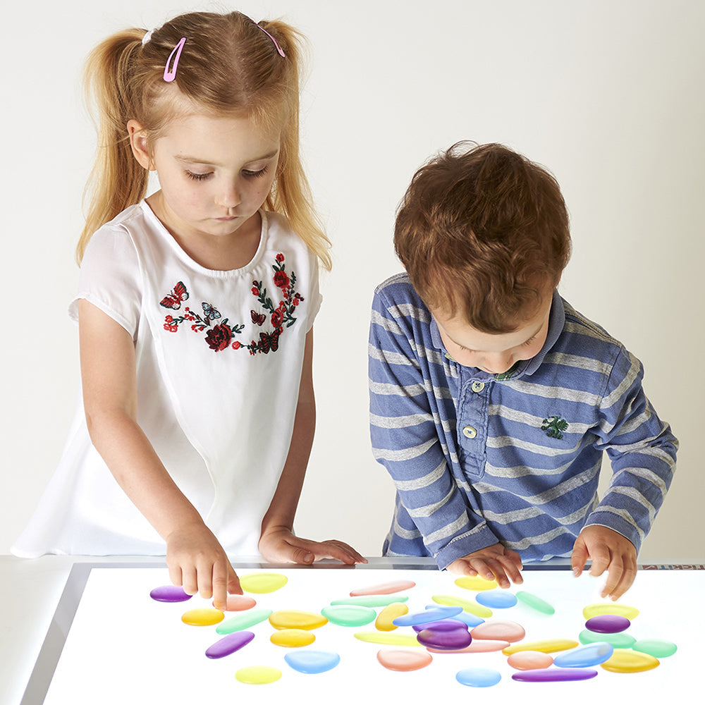 Kids Exploring Light Table Play with Translucent Rainbow Pebbles