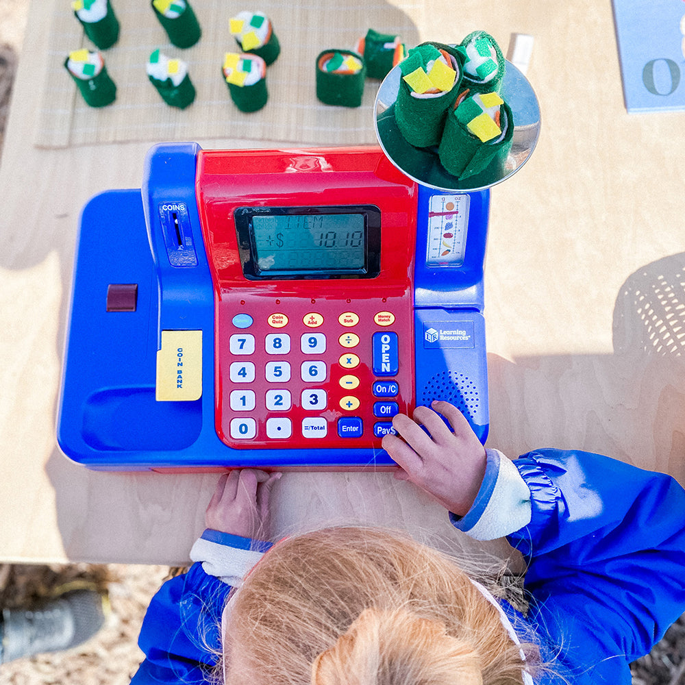 Kid Examining Pretend and Play® Teaching Cash Register