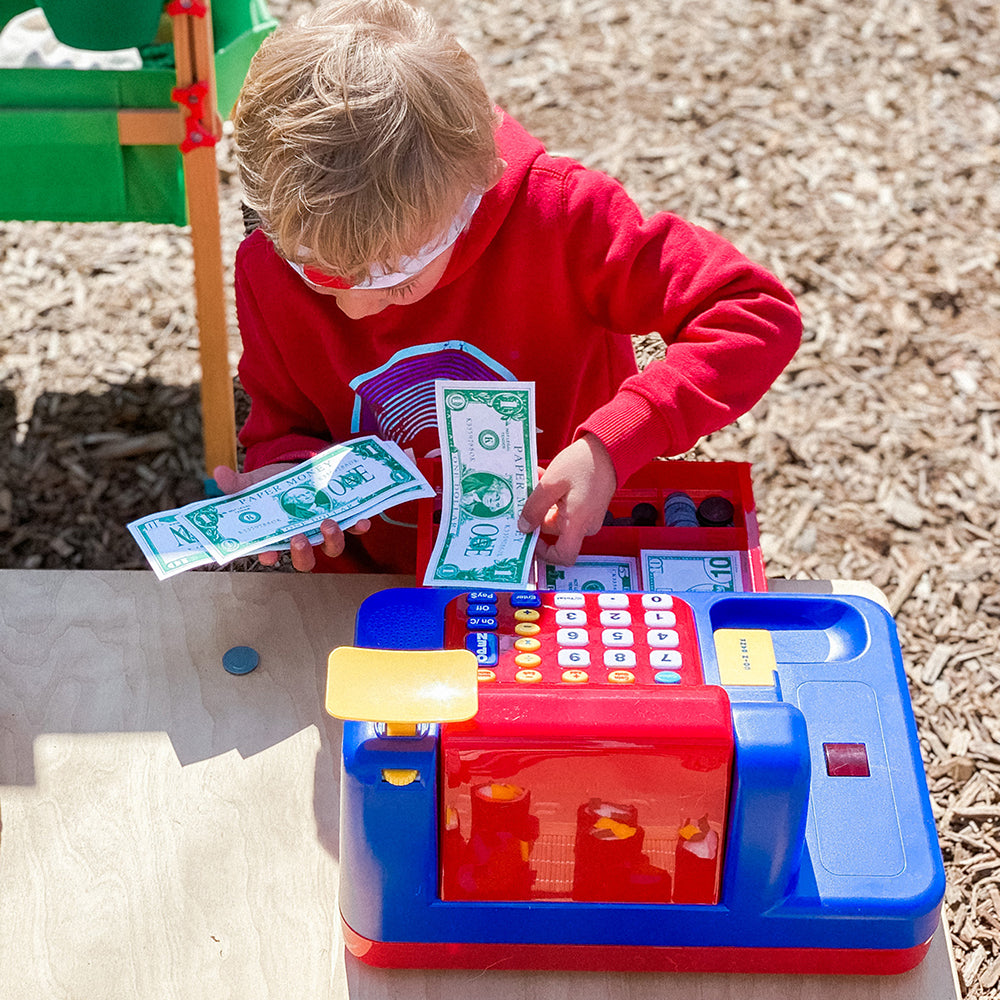Kid Interacting with Play Money in Register