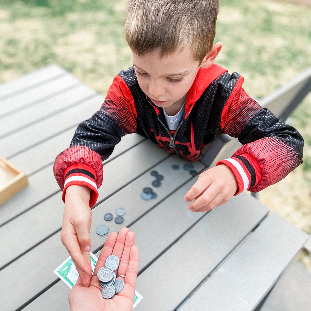 Kid Using Pretend Play Money to Learn Math