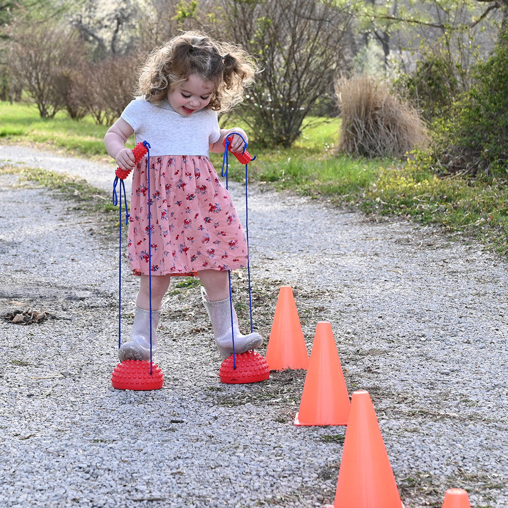 Kid Using Tactile Half-Sphere Stilts Outdoors