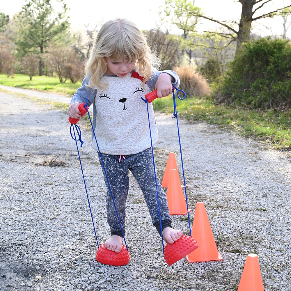 Kid Using Tactile Half-Sphere Stilts Outdoors