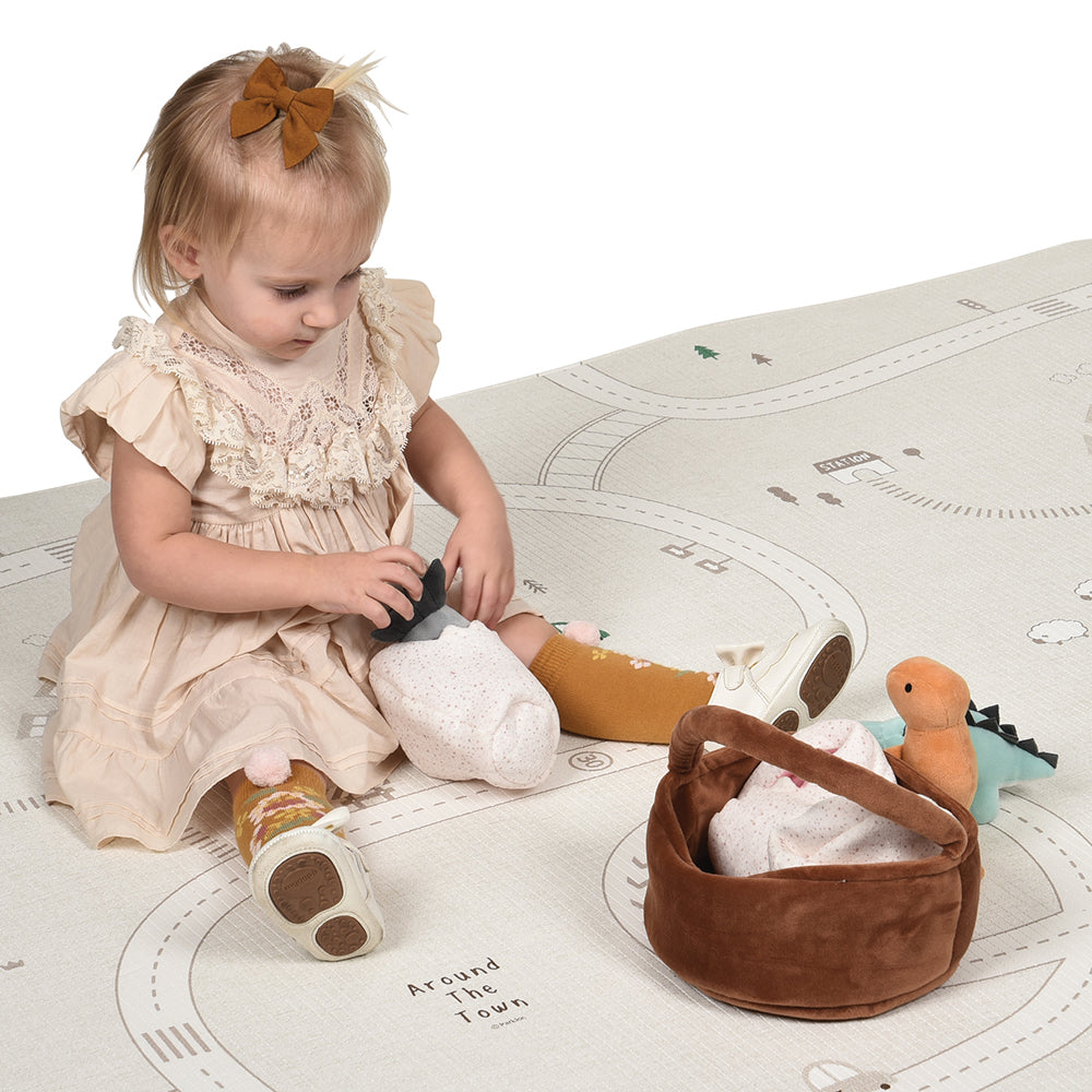 Toddler Playing With Triceratops in Plush Egg