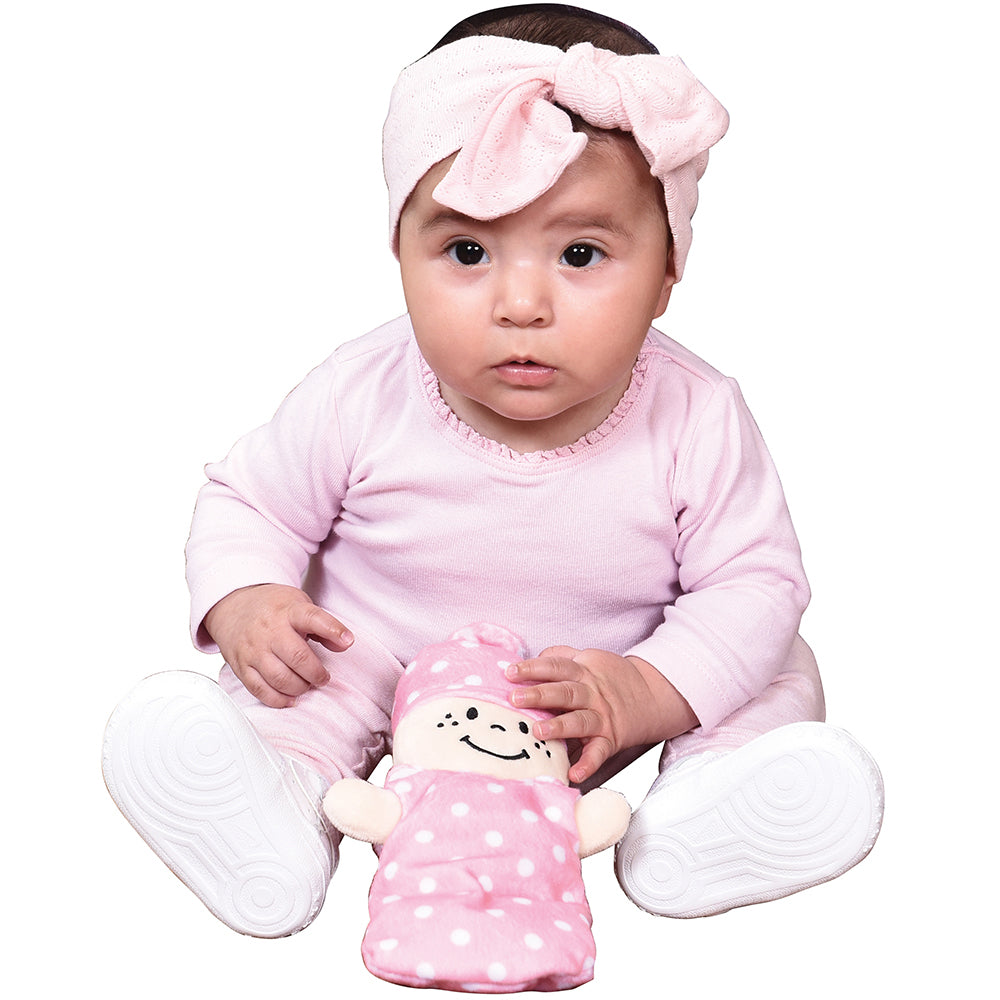 Baby in Pink Cuddling With Plush Doll