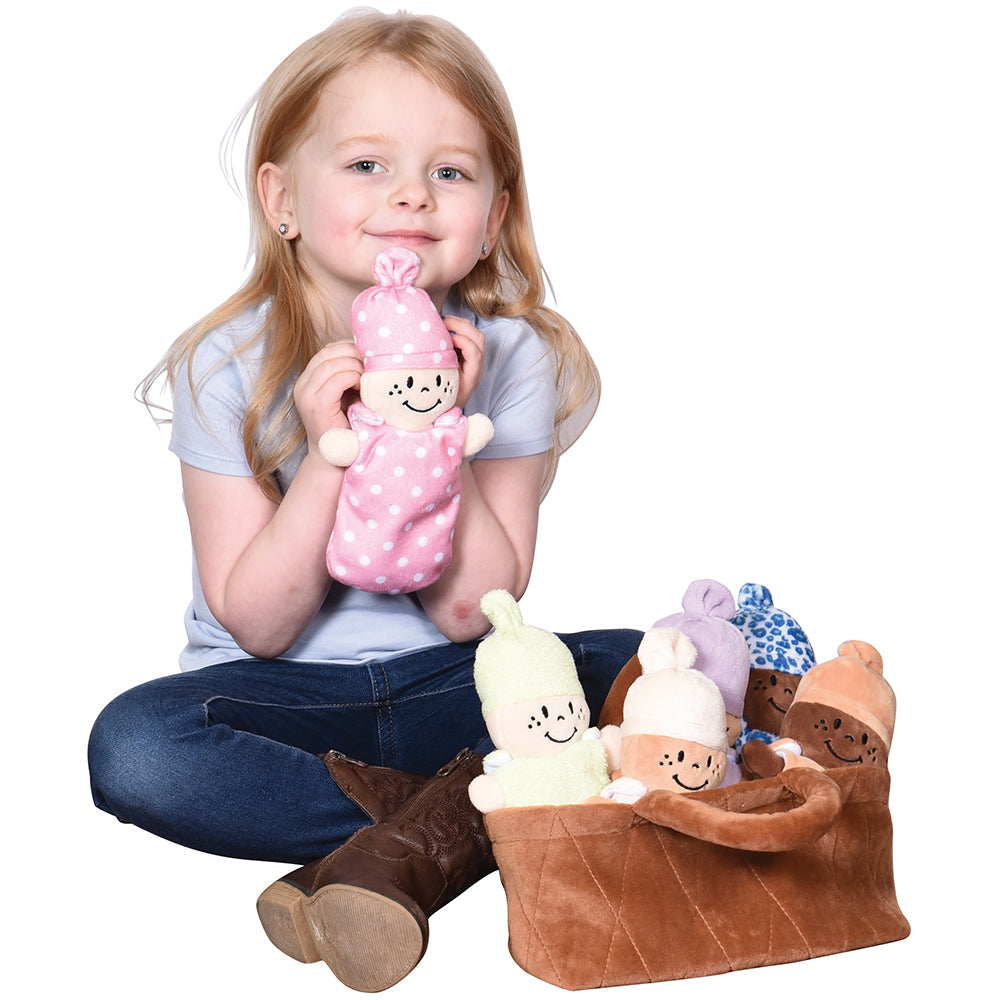 Kid Cuddling with Plush Basket of Babies