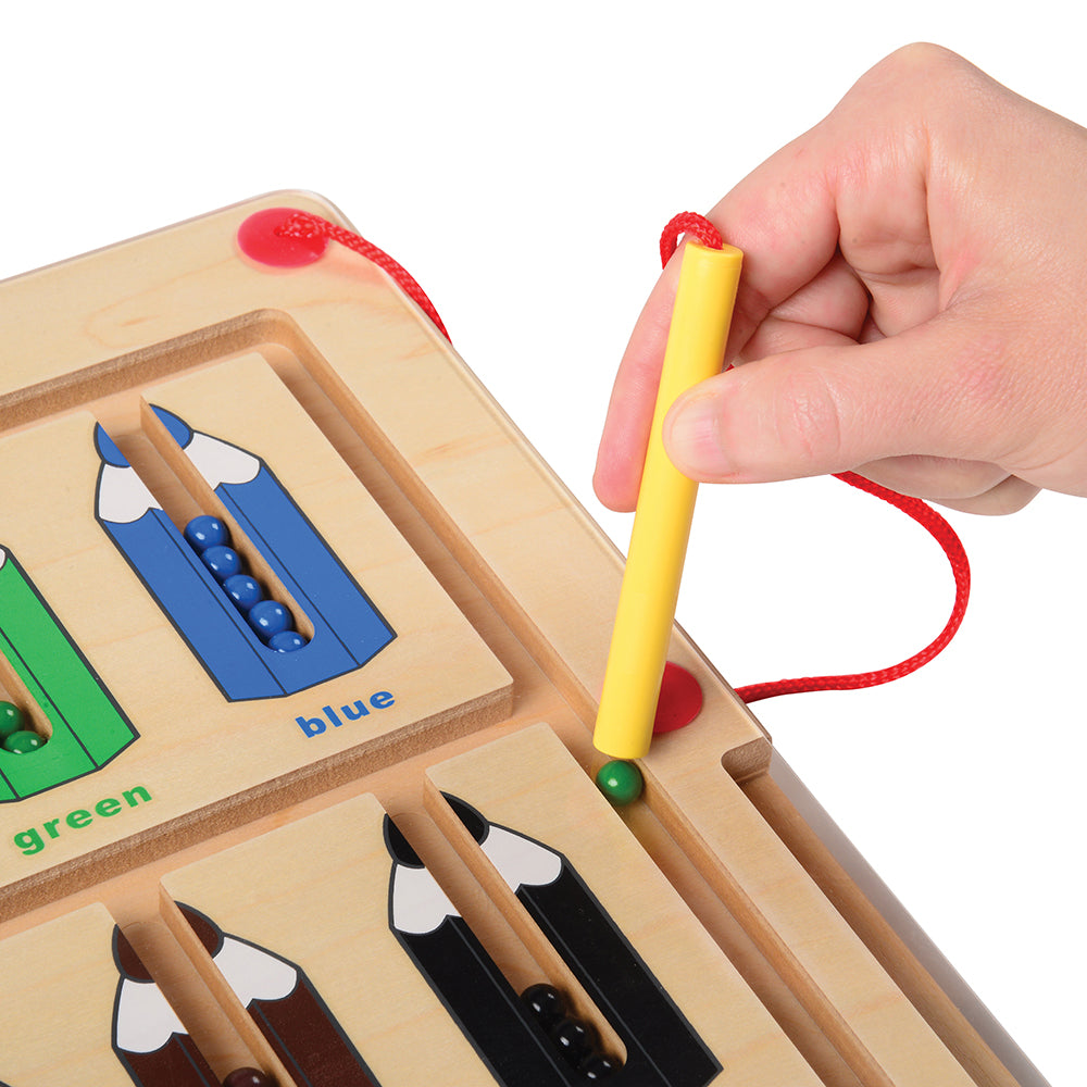Close-up of Using Attached Magnetic Wand to Move Colored Balls in Magnetic Color Matching Game