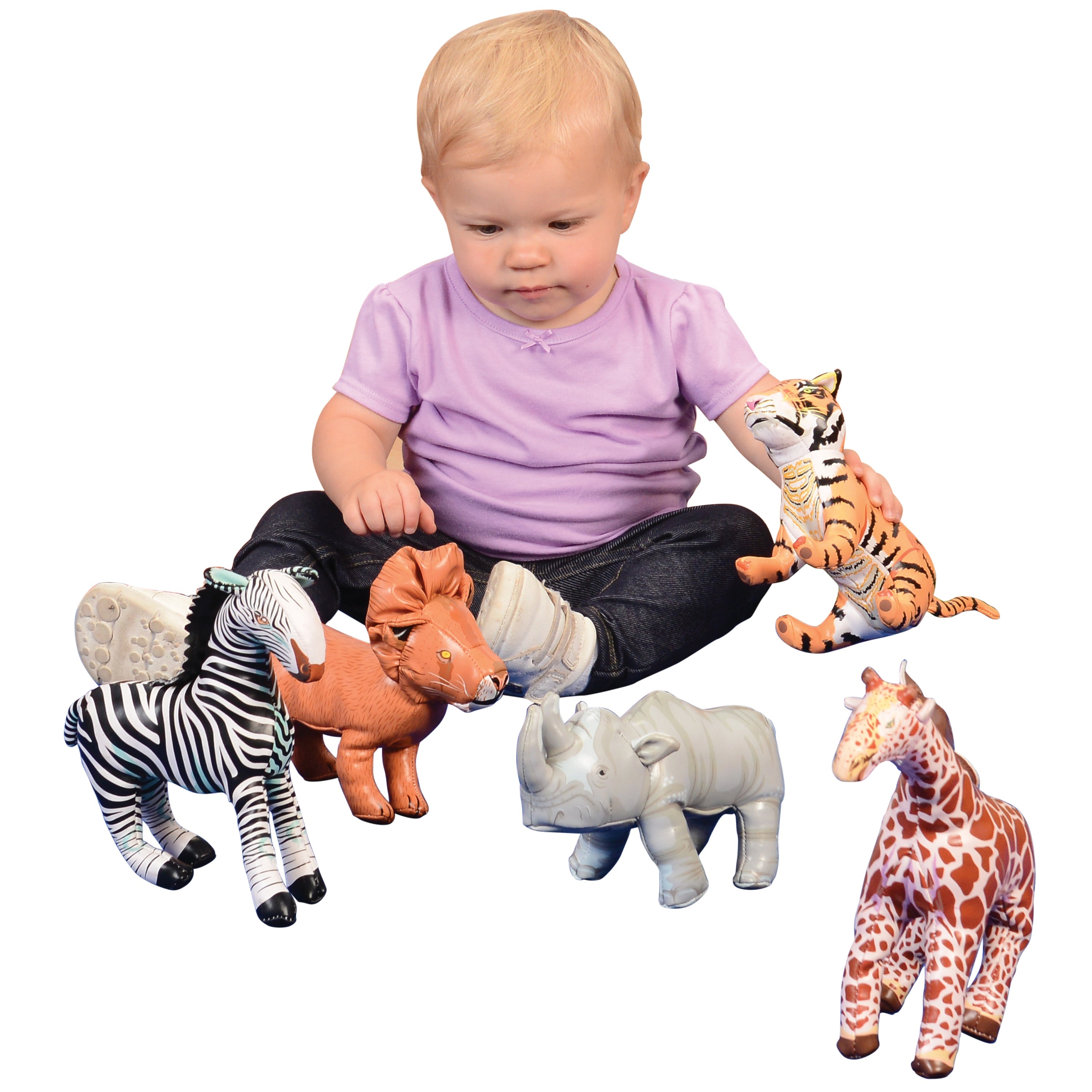 Baby playing with soft jungle animal figures on a white background
