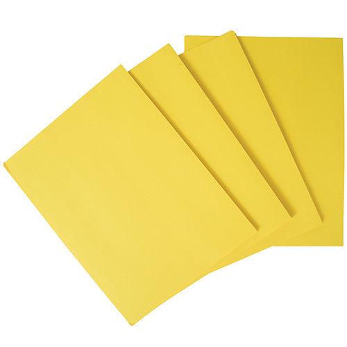 A stack of yellow construction paper, folded and arranged on a surface.