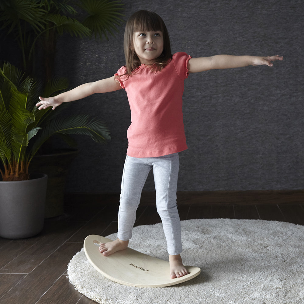 Kid Balancing On Wooden Balance Board