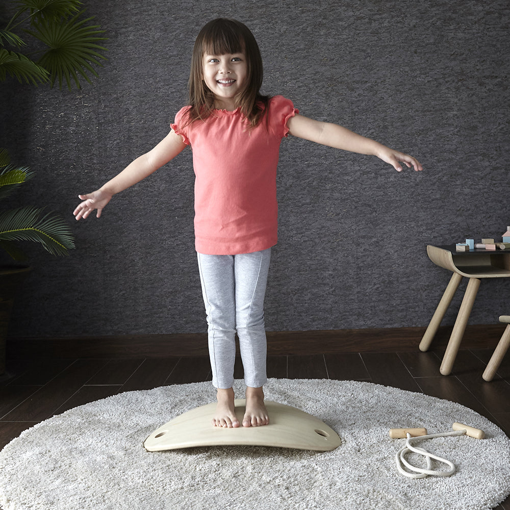 Kid Standing on Balance Board