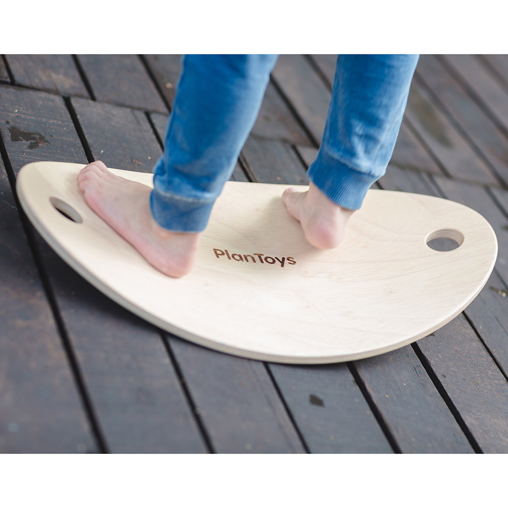 Close-Up Of Child's Feet on Balance Board