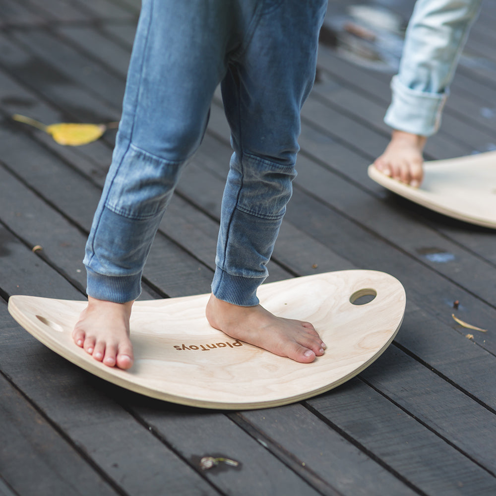 Close-Up Of Child's Feet on Balance Board