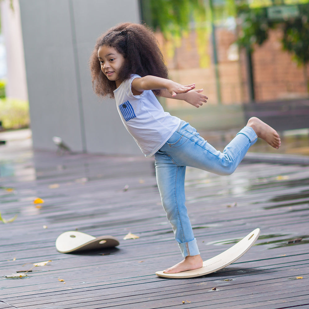 Kid Practicing Balance on Wooden Board